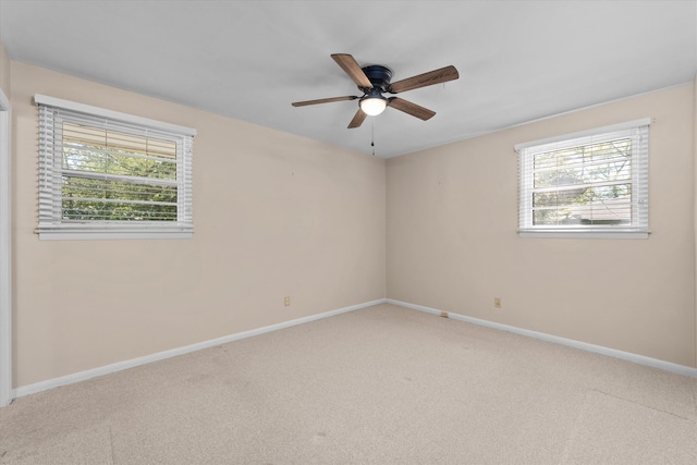 carpeted empty room featuring ceiling fan