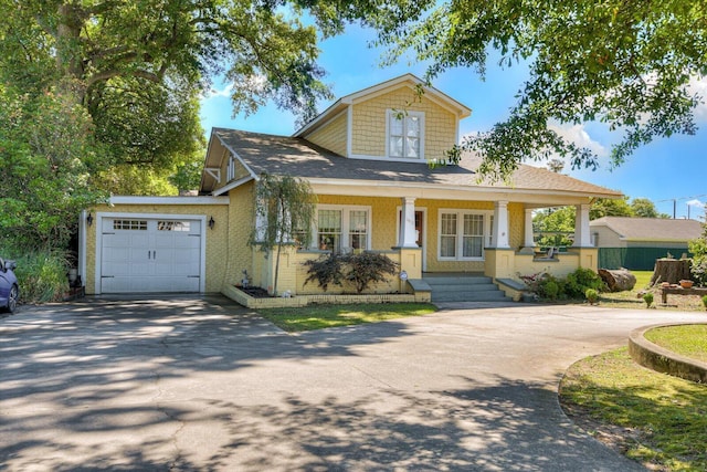 view of front facade with a porch and a garage