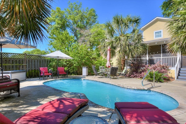 view of pool with a patio area and a sunroom