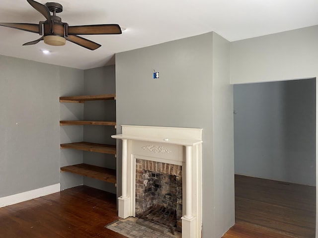 unfurnished living room featuring ceiling fan, dark hardwood / wood-style floors, and a brick fireplace