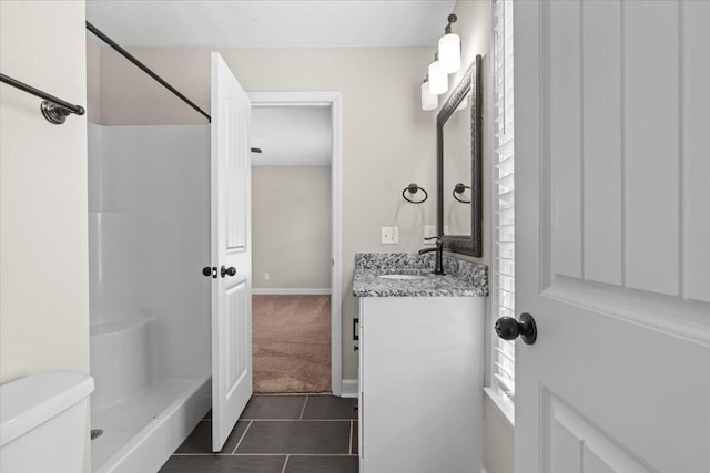 bathroom with toilet, tile patterned flooring, a shower, baseboards, and vanity