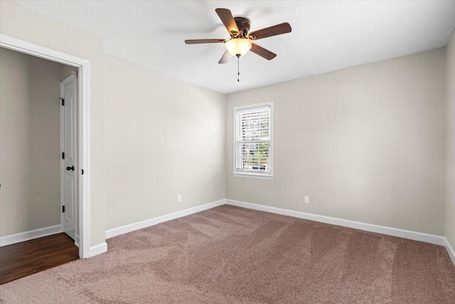 empty room with carpet flooring, baseboards, and a ceiling fan