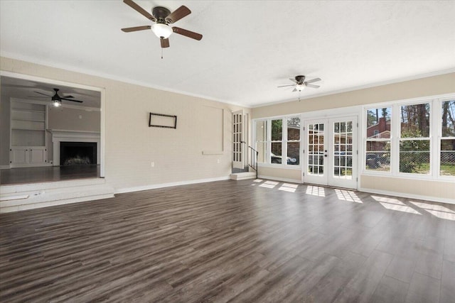 unfurnished living room with a ceiling fan, crown molding, french doors, and dark wood finished floors