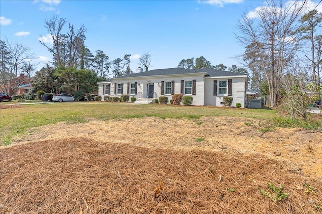 ranch-style home with a chimney, central AC, and a front lawn