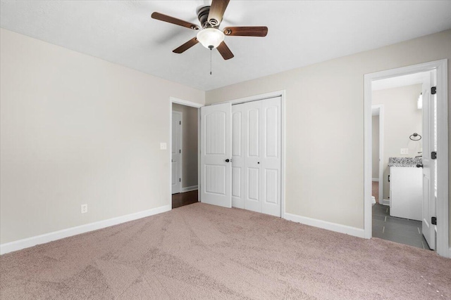 unfurnished bedroom featuring a ceiling fan, baseboards, a closet, and carpet floors