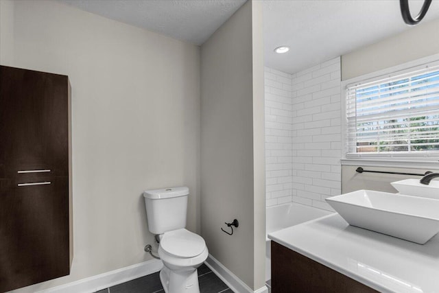 full bathroom featuring vanity, baseboards, a shower, tile patterned floors, and toilet