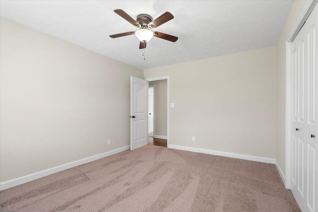 unfurnished bedroom with a closet, ceiling fan, baseboards, and carpet floors