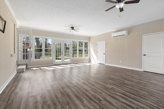 unfurnished living room featuring dark wood-style floors, french doors, a wall mounted air conditioner, and a ceiling fan