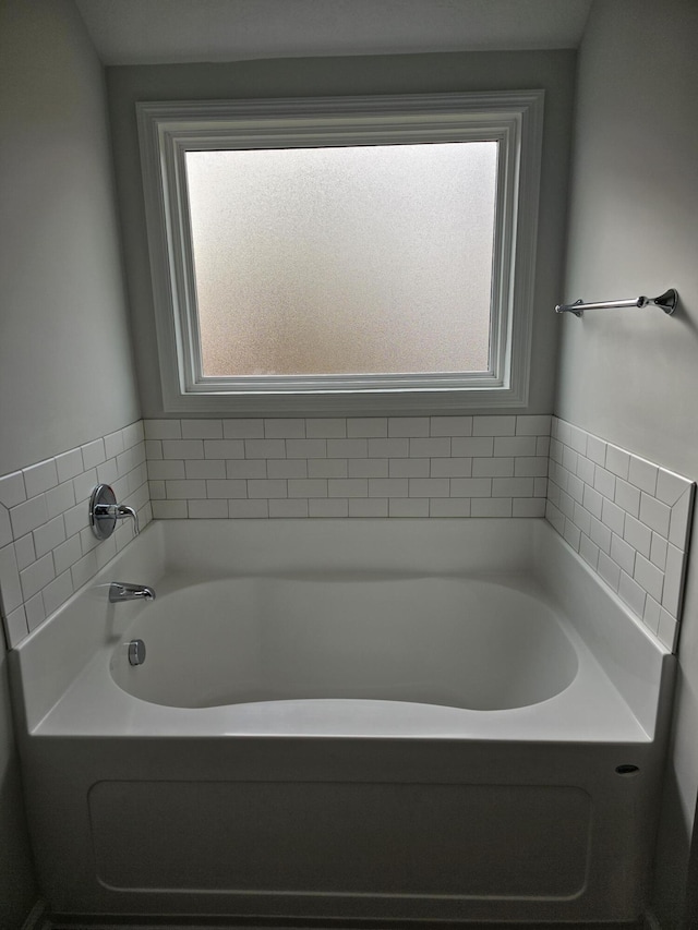 bathroom featuring a washtub and a healthy amount of sunlight