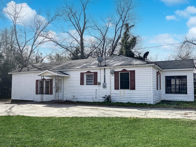 rear view of property with a lawn