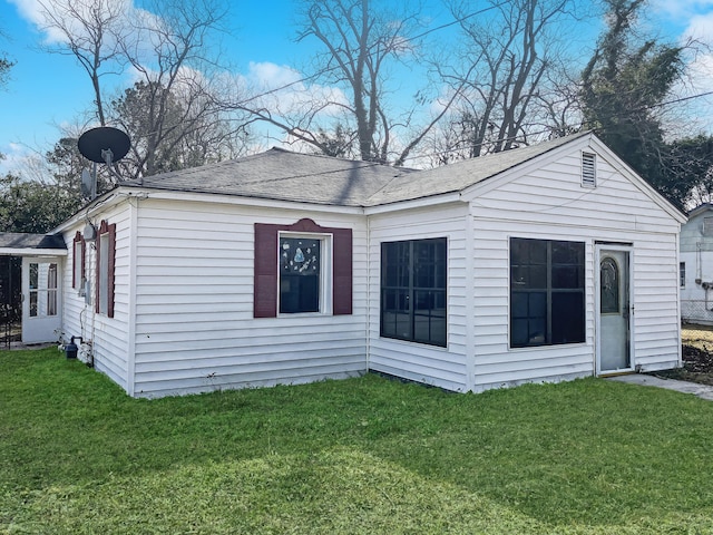 back of house with a yard