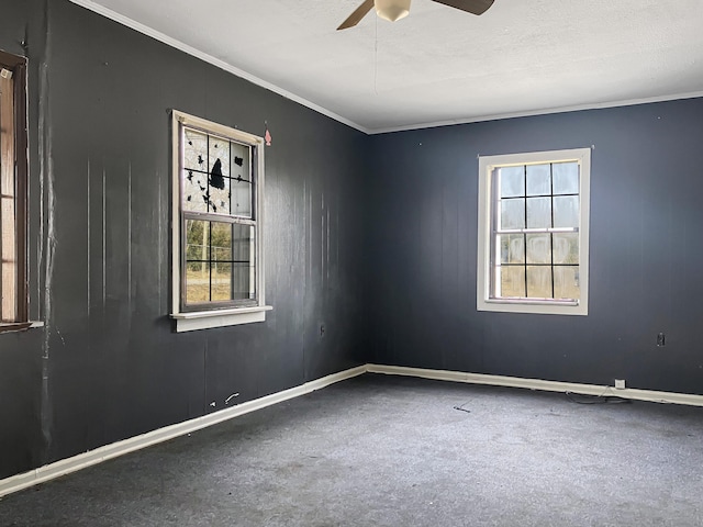 unfurnished room featuring ceiling fan and ornamental molding