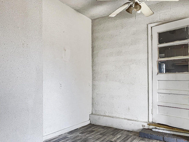 spare room featuring ceiling fan and dark hardwood / wood-style floors