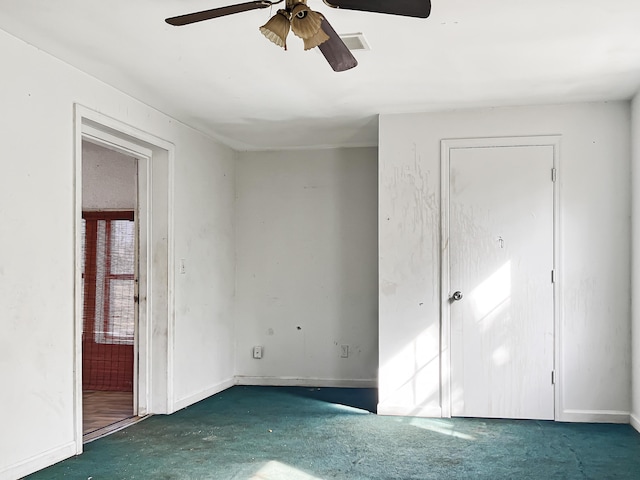 unfurnished bedroom featuring dark colored carpet and ceiling fan