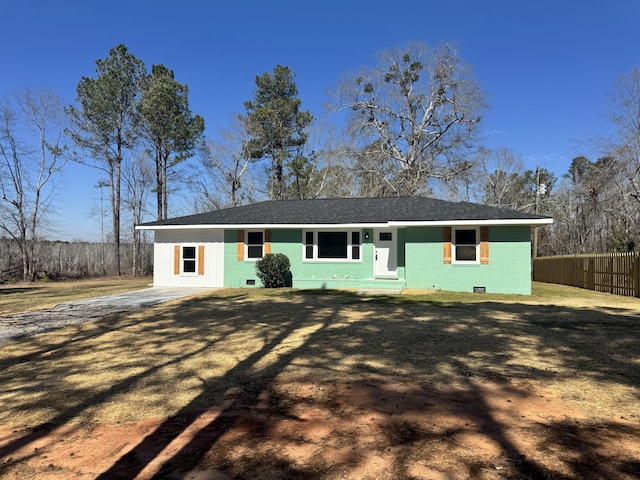 view of front of home featuring crawl space, a front yard, brick siding, and fence