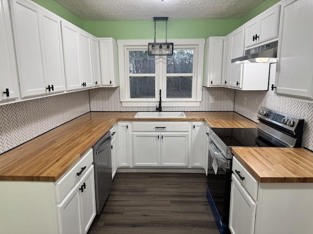 kitchen featuring stainless steel appliances, under cabinet range hood, white cabinetry, pendant lighting, and a sink