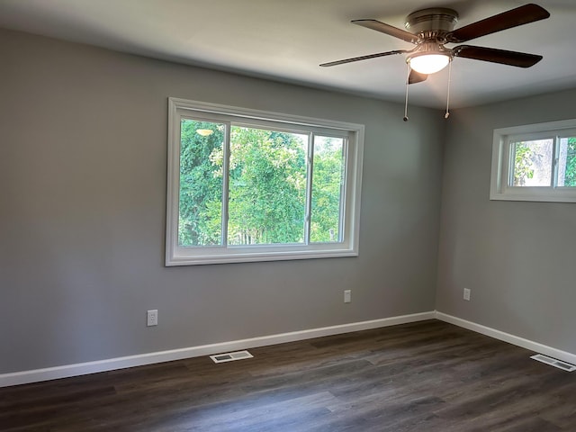 spare room featuring dark hardwood / wood-style floors and ceiling fan