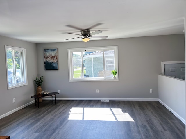 spare room featuring ceiling fan and dark hardwood / wood-style flooring