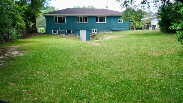 rear view of house featuring a yard