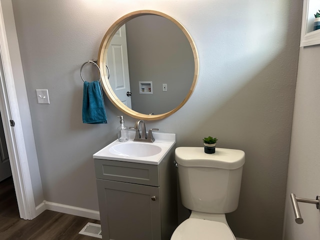 bathroom featuring hardwood / wood-style floors, vanity, and toilet