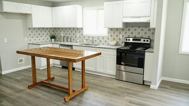 kitchen with sink, white cabinets, light hardwood / wood-style flooring, and appliances with stainless steel finishes