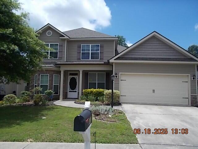 437 Sebastian Dr, Grovetown, GA 30813 - view of front facade with concrete driveway, an attached garage, and a front lawn