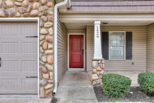 doorway to property with a garage