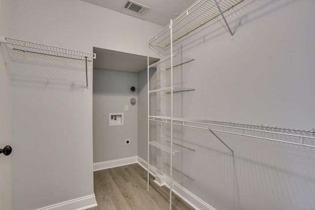 laundry room featuring hookup for an electric dryer, washer hookup, and hardwood / wood-style flooring