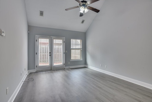 unfurnished room featuring hardwood / wood-style flooring, ceiling fan, high vaulted ceiling, and french doors