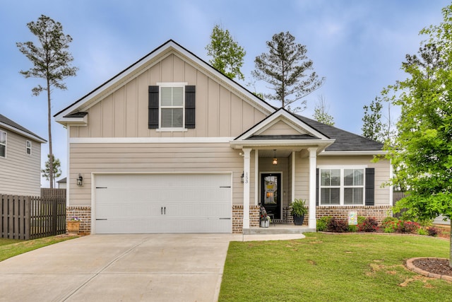 craftsman house featuring brick siding, board and batten siding, fence, and a front yard