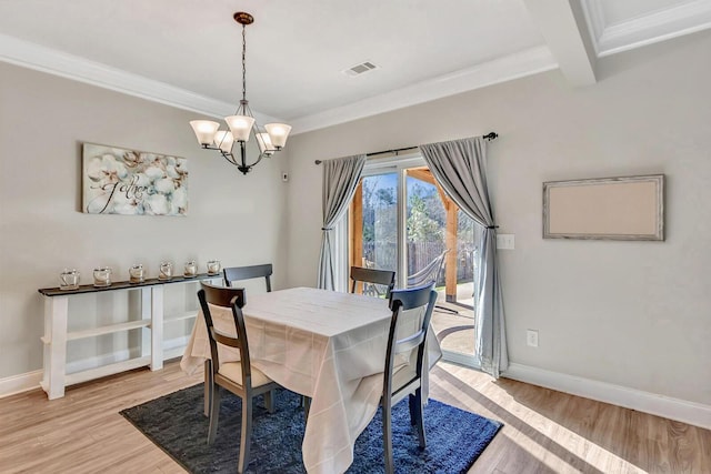 dining area featuring ornamental molding, beam ceiling, a chandelier, and light hardwood / wood-style floors