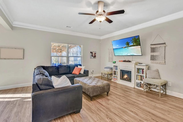 living room featuring crown molding, ceiling fan, and light wood-type flooring