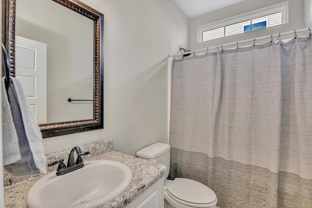 bathroom with vanity, toilet, and a shower with shower curtain