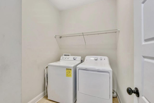 clothes washing area with washing machine and dryer