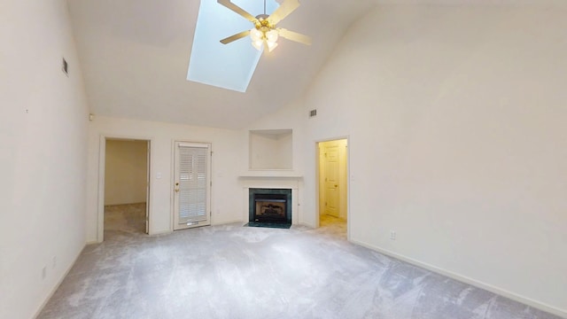 431 Connemara Trl, Evans, GA 30809 - unfurnished living room featuring high vaulted ceiling, a ceiling fan, light carpet, a fireplace with flush hearth, and a skylight