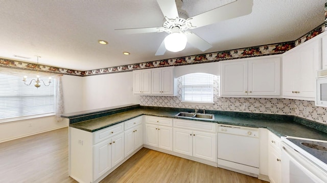 431 Connemara Trl, Evans, GA 30809 - kitchen featuring white appliances, dark countertops, light wood finished floors, a peninsula, and recessed lighting