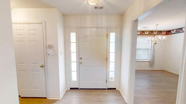 431 Connemara Trl, Evans, GA 30809 - foyer entrance featuring light wood finished floors, plenty of natural light, and a chandelier