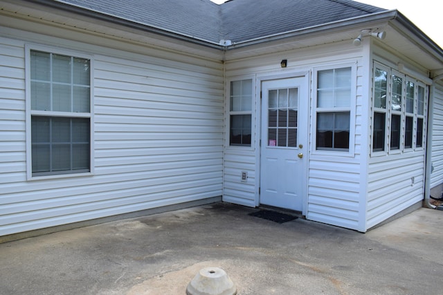 431 Connemara Trl, Evans, GA 30809 - property entrance with roof with shingles and a patio