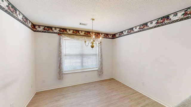 431 Connemara Trl, Evans, GA 30809 - unfurnished dining area featuring a chandelier, light wood-style flooring, and a textured ceiling