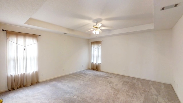 431 Connemara Trl, Evans, GA 30809 - empty room featuring a tray ceiling, a ceiling fan, and light carpet