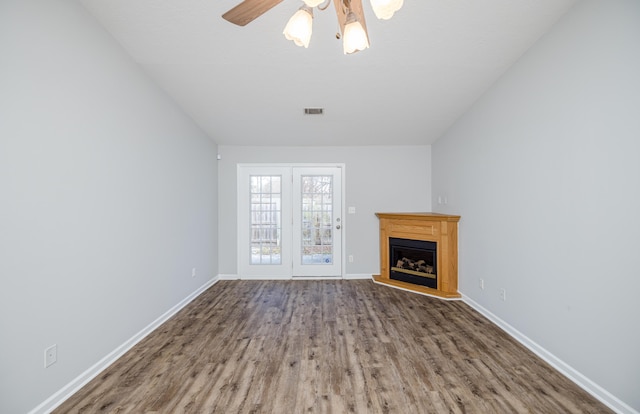 unfurnished living room featuring ceiling fan and wood-type flooring