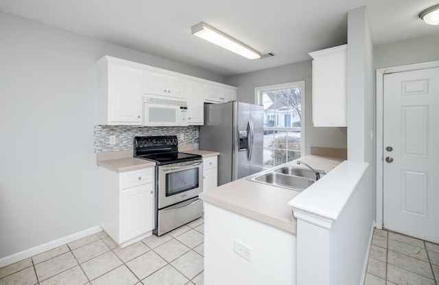 kitchen featuring sink, white cabinetry, tasteful backsplash, light tile patterned floors, and appliances with stainless steel finishes