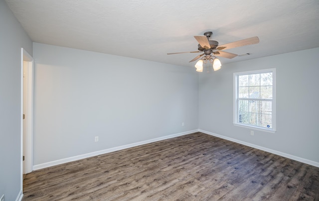 unfurnished room with dark hardwood / wood-style flooring, a textured ceiling, and ceiling fan