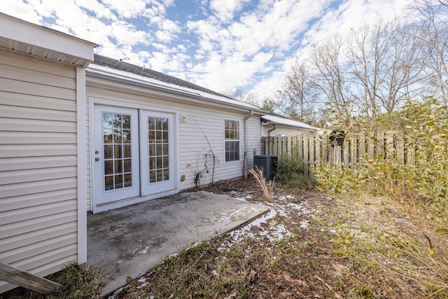 view of side of property with cooling unit and a patio area