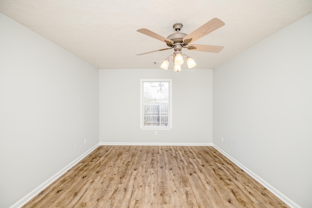 spare room featuring ceiling fan and light wood-type flooring