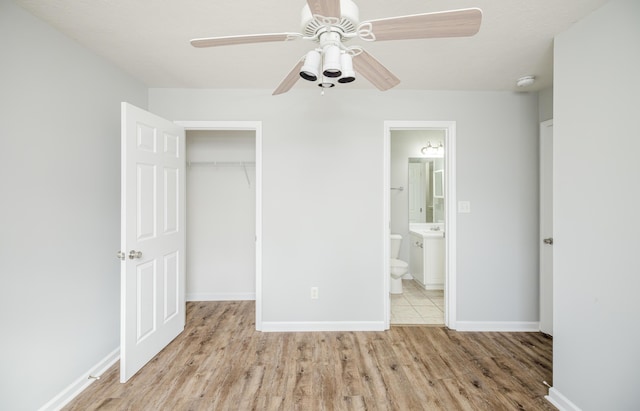 unfurnished bedroom with ensuite bath, light hardwood / wood-style flooring, a closet, and ceiling fan