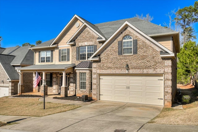 craftsman house with covered porch, concrete driveway, a shingled roof, brick siding, and central AC unit