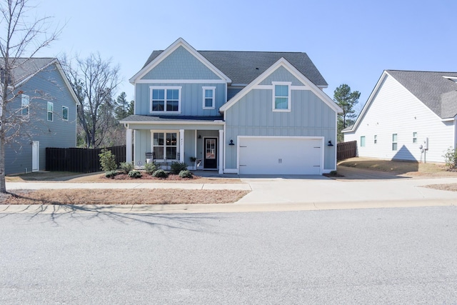 view of front of house with an attached garage, covered porch, fence, concrete driveway, and board and batten siding