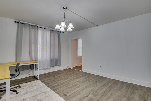 office area featuring hardwood / wood-style floors and a notable chandelier