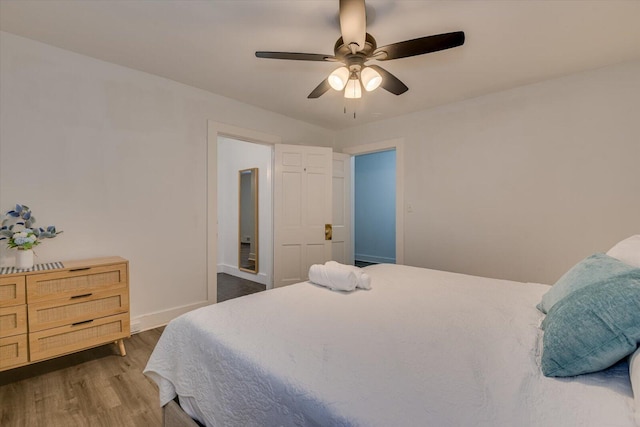 bedroom with ceiling fan and hardwood / wood-style floors